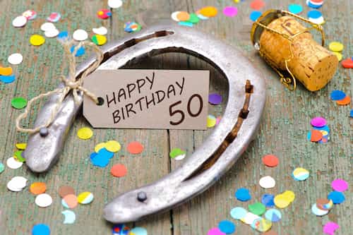 Lucky 50th Birthday Party Ideas for Men. Horseshoe With a Happy 50th Birthday tag attached.