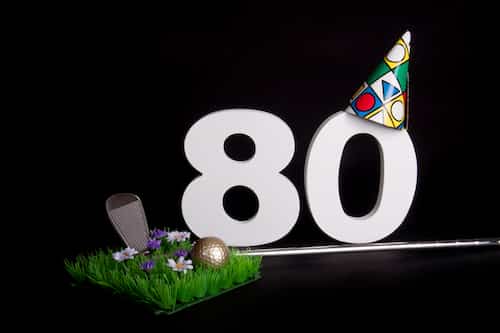 Plan an 80th birthday party with a golf theme. 80th Birthday celebration with golf club and ball.