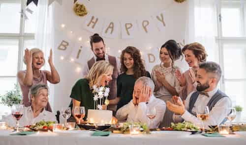 A surprise party to be remembered:  Happy Birthday! A man looking shocked and joyful as he is surrounded by his loved ones at his surprise birthday party.