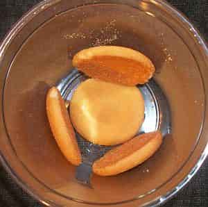 Vanilla Wafers in the bottom of a dessert cup.