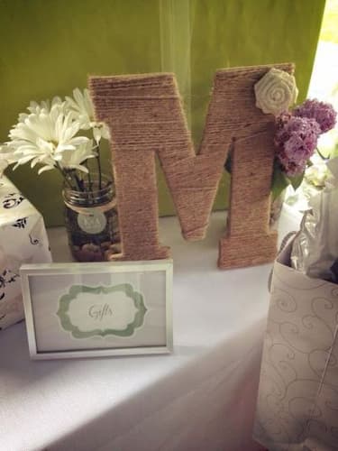 Add a Personal Touch to Your Bridal Shower Invitations. Bridal Shower Gift Table with a Jute Wrapped Letter "M" and Flowers.