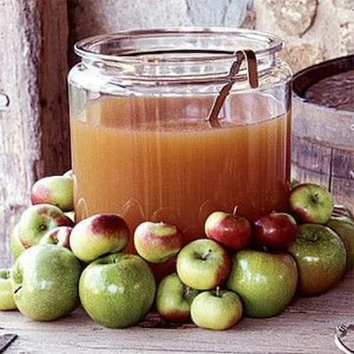 Sip on some Apple Cider while celebrating the Upcoming Wedding. Punch Bowl of Apple Cider surrounded by Apples.
