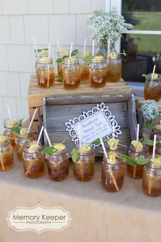 Serve in Mason Jars for a Charming Touch to any Punch. Sweet Tea in Mason Jars with Lemons and Straws.