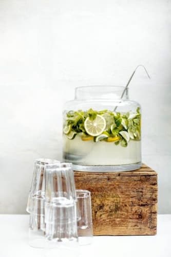 Sharing Laughter and Memories Over A Cup of Punch. Punch Bowl on top of a Wooden Riser with clear punch cups.