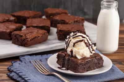 Delicious brownie with a scoop of ice cream on top.