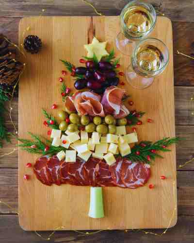 Easy Christmas Charcuterie Board Ideas To Try Christmas charcuterie board ideas showcasing a Christmas tree filled with holiday treats.