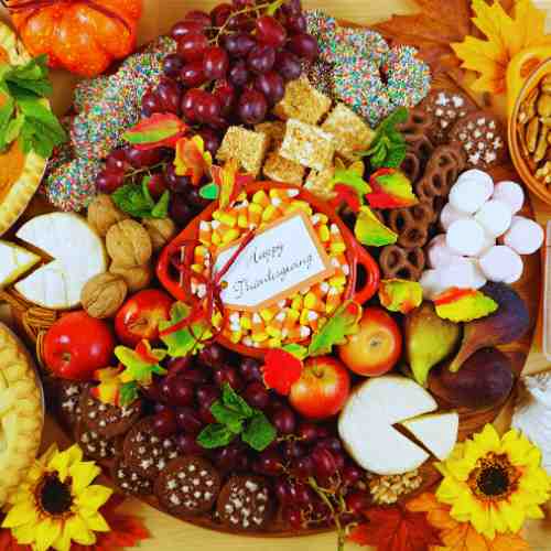 Charcuterie Board Thanksgiving: Think Bountiful Display A beautifully arranged charcuterie board for Thanksgiving featuring fall flavors and ingredients.