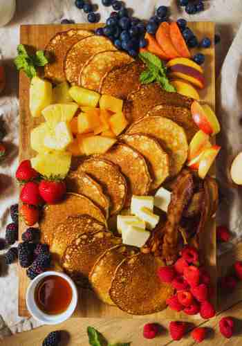 Start Your Day With Creative Charcuterie Board Ideas Creative breakfast charcuterie board ideas with pancakes, bacon, and fresh fruit.