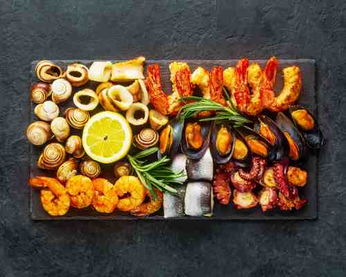 Seafood Charcuterie Board: Sea The Good! A beautifully arranged seafood charcuterie board featuring an assortment of fresh seafood.