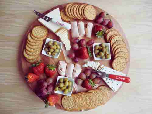 Charcuterie Utensils: Essential For A Perfect Serving Experience Charcuterie board with utensils designed for handling cheeses, meats, and garnishes.