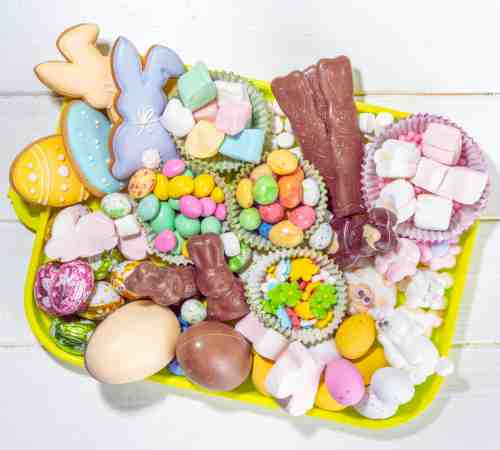 Easter Charcuterie Boards: Let's Hop To It! Charcuterie board for Easter offering themed treats in a variety of pastel colors.