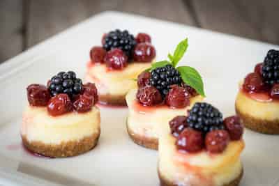 Mini Cheesecakes topped with fruit.