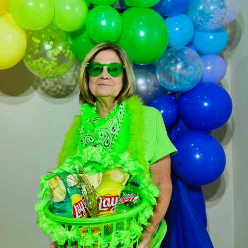 Color Party Green Ideas: See Your Outfit And Your Snacks Through Green Colored Glasses Color Party attendee wearing green attire, accessorized with scarf, boa and green colored glasses.