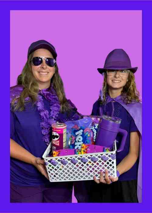 Color Party Purple: Create A Purple Haze With Color Coordinated Outfits And Snacks Two guests attending a purple color party dressed in purple holding a basket of purple snacks.
