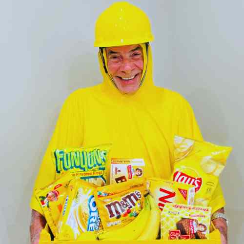 Yellow Items For Color Party: Let The Yellow Color Shine Guest dressed in yellow holding an array of yellow snacks for Color Party.