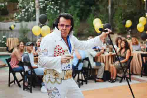 Elvis impersonator entertaining a crowd.