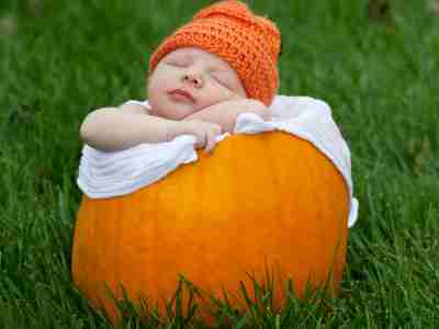 Newborn baby in a fall pumpkin. Fall Baby in a Pumpkin