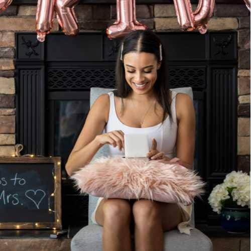 Gift opening game at the bridal shower. A bride-to-be opening a gift at her bridal shower.