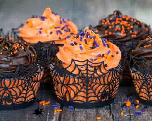 Add A Festive Touch To Cupcakes With Stylish Halloween Cupcake Wrappers Halloween cupcake wrappers with a spider web design.