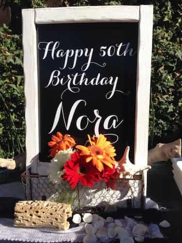 Celebrate a 50th birthday with a happy birthday chalkboard sign.