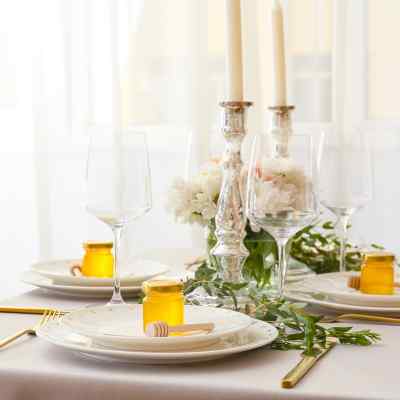Send guests home with honey wedding favors. DIY honey wedding favors placed at each place setting.