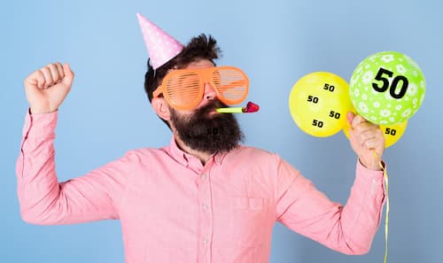 The Moment of Surprise at a 50th Birthday Party. Man Decked Out for a Surprise 50th Birthday Party.
