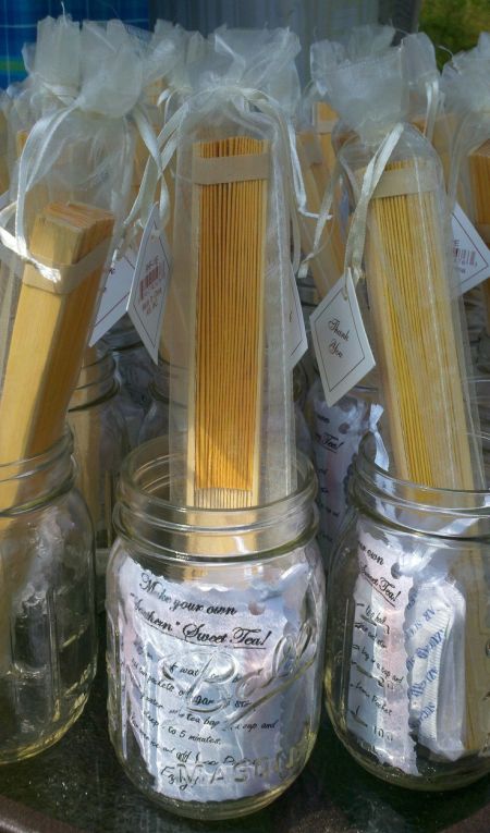 Wedding Fans Displayed In Mason Jars